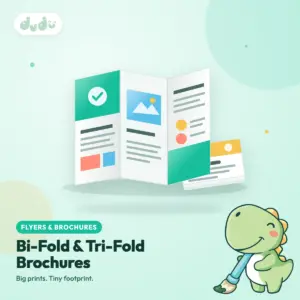 Folded tri-fold brochure standing open beside a stack of bi-fold brochures