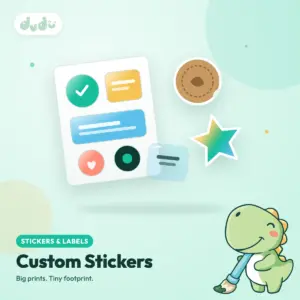 Custom stickers in assorted shapes and materials, some on a kiss-cut sheet and some die-cut as loose pieces