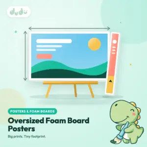 Large printed foam board poster standing on an easel beside a long narrow board