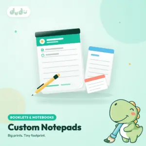 Stack of custom printed tear-off notepads with a glued top edge and a pen