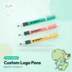 Three custom branded ballpoint pens in mint, coral and yellow with a printed logo on the barrel