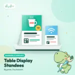 Matt foam board table standee propped up by a stand at the back, sitting on a counter top