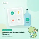Clear transparent kiss-cut sticker labels on a backing sheet, with one label applied to a glass bottle