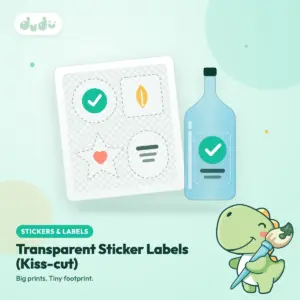 Clear transparent kiss-cut sticker labels on a backing sheet, with one label applied to a glass bottle